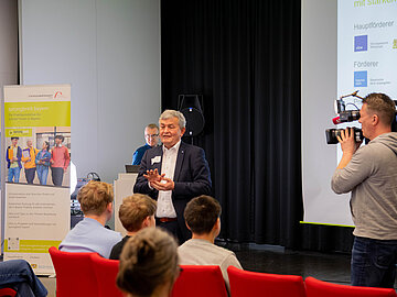 Bertram Brossardt auf der Bühne der sprungbrett bayern Veranstaltung (©sprungbrettbayern)